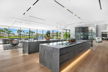 Smooth finished ceiling with linear detail above an open kitchen island