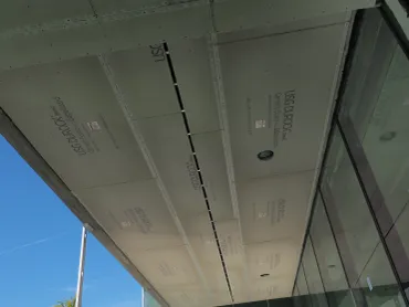 Drywall soffit hung along an exterior glazed walkway