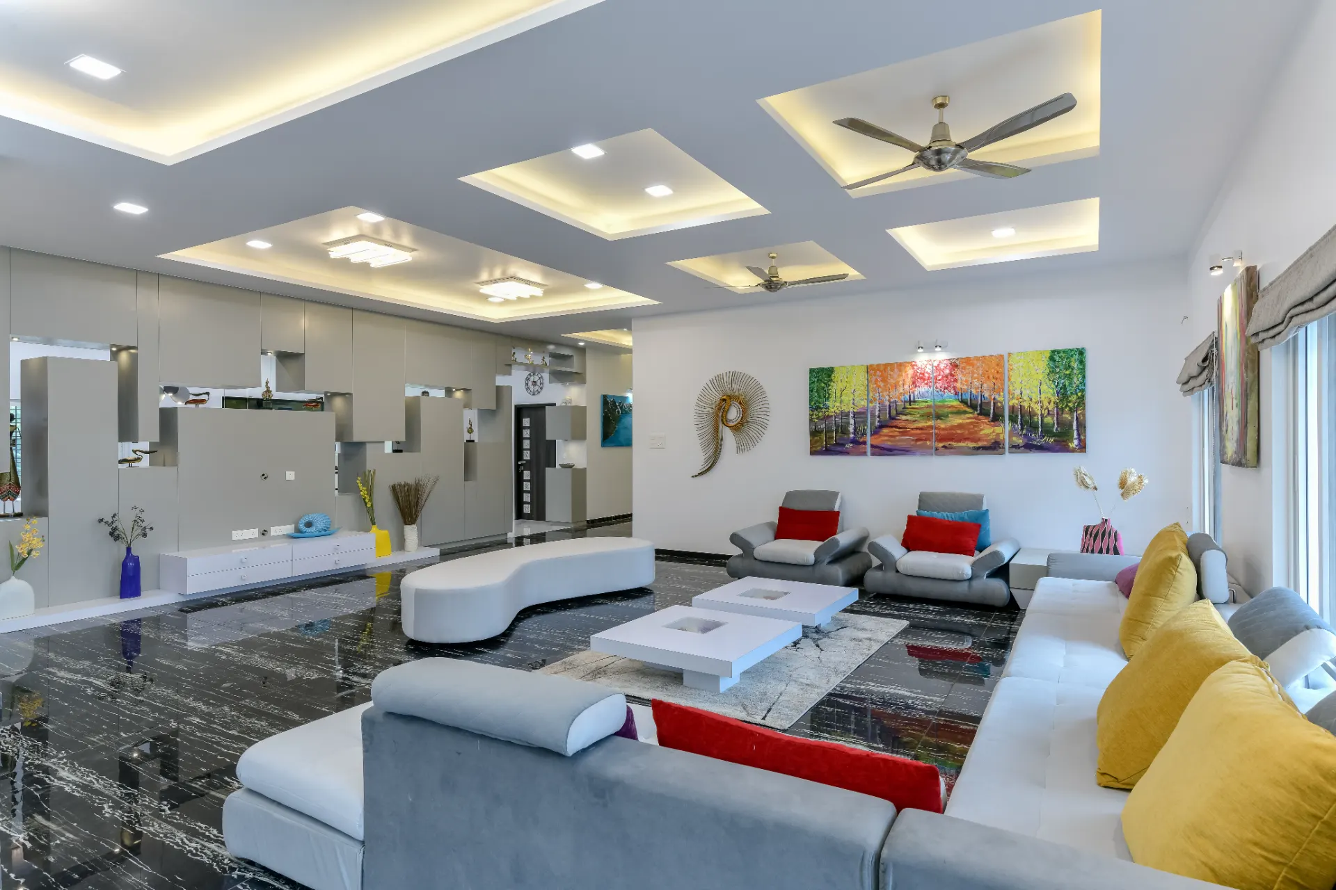Open living area with a layered stepped ceiling and integrated lighting